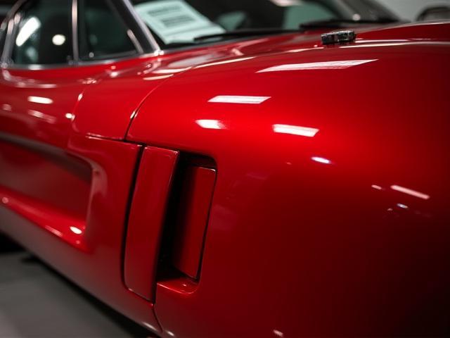 Gleaming red sports car after full detailing and ceramic coating