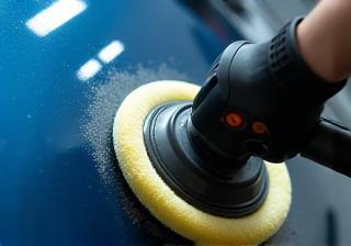 Close-up of machine polishing a car's paintwork